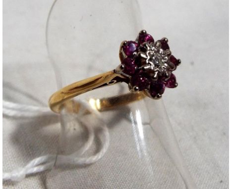 A lady's 18 carat gold ruby and diamond cluster ring, size L and a half, approx weight 3.2 grams