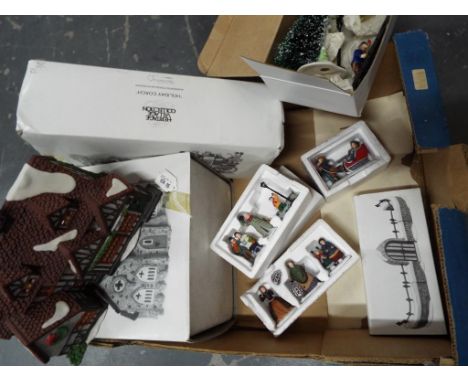 A Heritage collection of Dickens Series ceramic Christmas display figurines and buildings