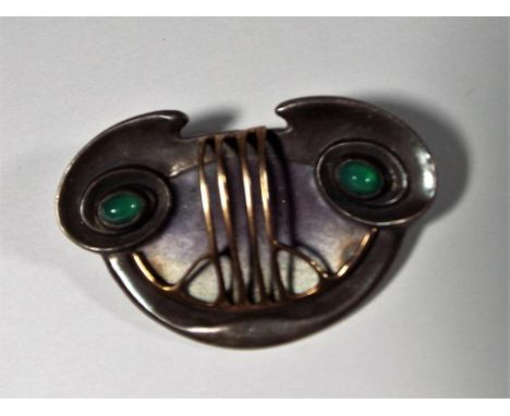 Theodor Fahrner - A lady's white metal brooch with art nouveau decoration set with green cabouchon, stamped verso 950, 4cm x 