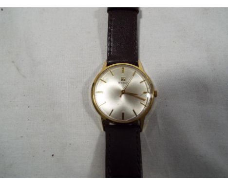 A gentleman's Tissot wristwatch, manual wind, silvered dial with gilded raised batons, gilded hour, minute and second hands, 