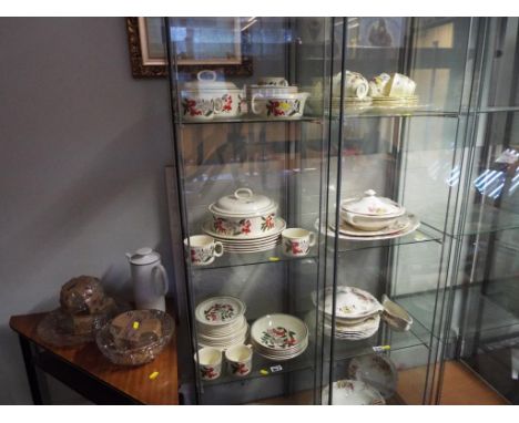 Approximately 49 pieces of ceramic tableware by J & G Meakin decorated in the Trend pattern displayed on four shelves