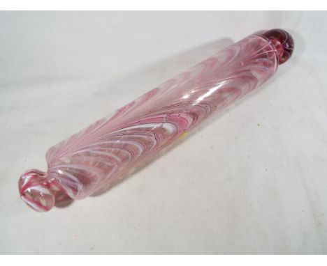 A late 19th C / early 20th C glass rolling pin, the hand blown cylinder with handles and pink and white inclusion trails, app