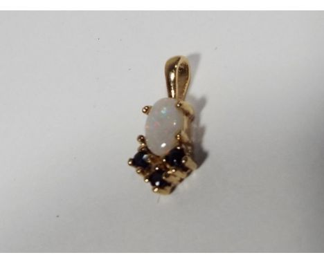 A lady's hallmarked 9 carat gold opal and sapphire pendant, approx weight 0.6 grams