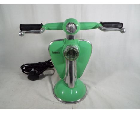 An unusual table lamp in the form of a Lambretta in lime green