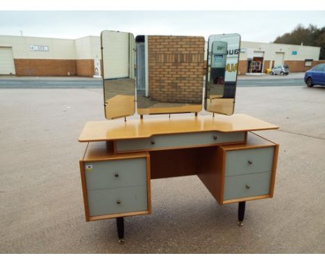 A light wood dressing-table with triple mirror above 133 cm (h) x 124 cm x 47 cm