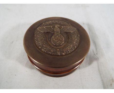 A snuff box displaying German eagle and swastika. Estimate £40 - £60