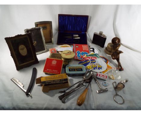 A good mixed lot to include a collection of tobacco tins, an art deco style lady, picture frames, vintage car stickers, a bar