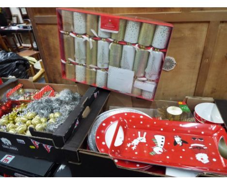 Christmas decorations - three boxes containing a large collection of Christmas decorations, tableware, Christmas crackers, a 