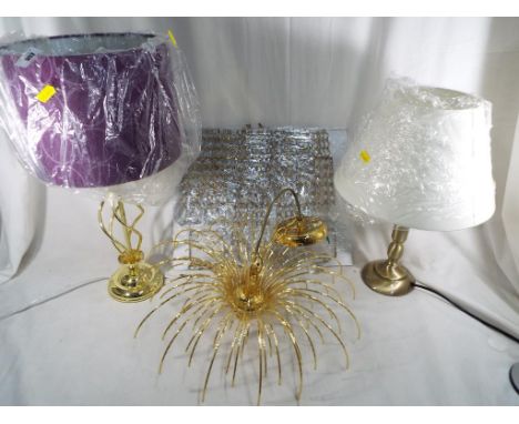 A yellow metal fountain effect chandelier with crystal drops, and two modern table lamps with shades - (3)