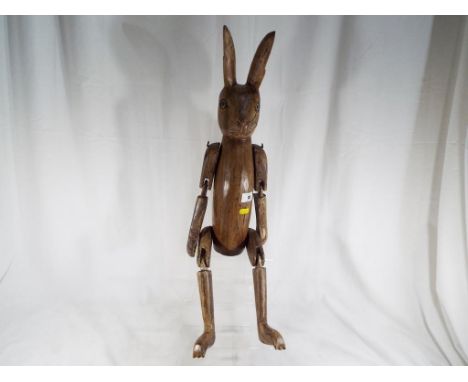 A wooden carved shelf rabbit 70 cm (h). Estimate £30 - £50