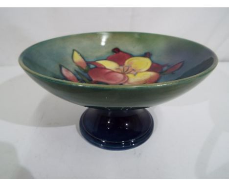 Moorcroft - a Moorcroft pottery ceramic tazza, decorated with freesia on a green ground, signed to the base, approximately 9.