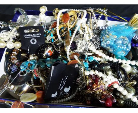 A large box containing a very large quantity of costume jewellery to include bangles, rings, necklaces, bracelets, trinket bo