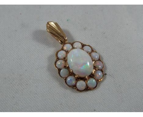 A lady's 9ct gold pendant set with a cluster of opal Est £20 - £40