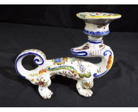 A vintage tin glaze dragon candlestick. Estimate £60 - £80