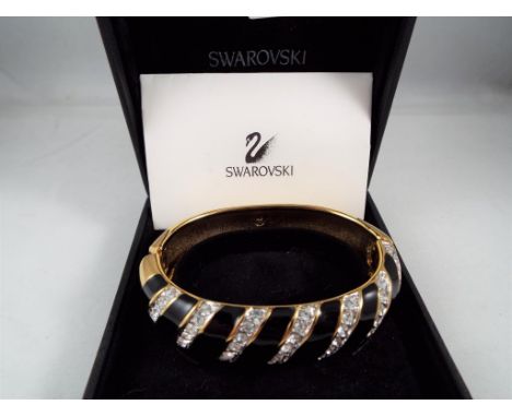 Swarovski - a Swarovski crystal bangle set with Swarovski crystals, stamped with makers mark on the inside of the bangle, wit