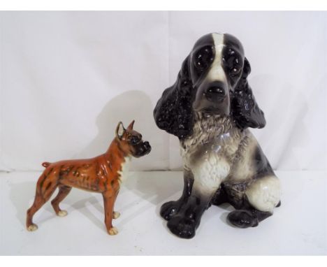 Goebel - two Goebel dog figurines to include large model of a spaniel, approximately 28 cm [h] and a boxer dog, marked CH617 