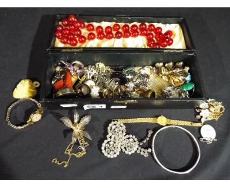 A jewellery box containing a quantity of vintage costume jewellery to include brooches, necklaces, watches by Oris and Rotary