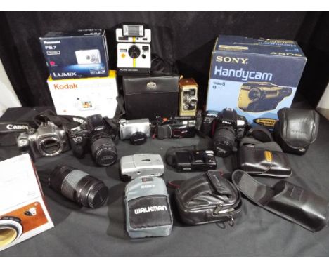 Photography - a large quantity of photographic equipment to include Canon EOS 30 camera with additional lens, Olympus Praktic