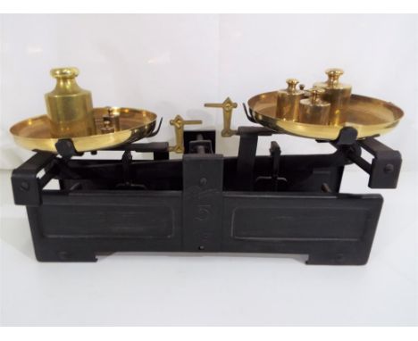 A vintage kitchen scales with weights.