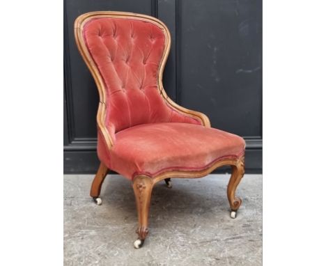 A Victorian walnut and button upholstered nursing chair.&nbsp; 