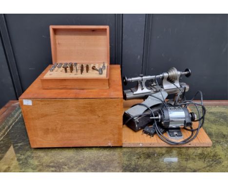 Tools: a watchmaker's electric lathe, with foot pedal; together with a boxed part set of related tools. 