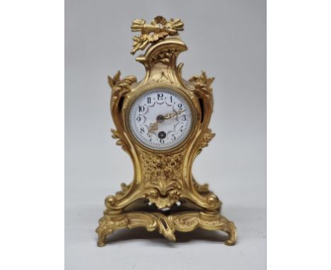 A good Louis XV style gilt brass mantel clock, with painted enamel dial, 23cm high. 
