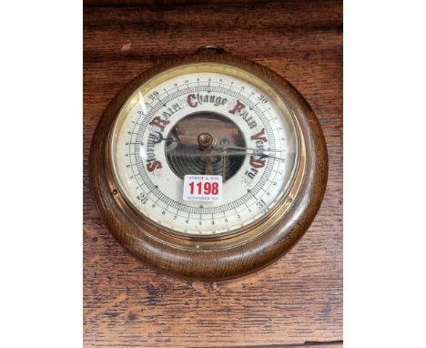 An oak aneroid barometer, 21.5cm diameter. 
