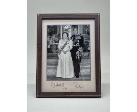 A signed black and white photograph of HRH Queen Elizabeth II and Prince Philip, dated 1989, I.21.5 x 16.5cm, in leather ease