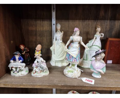 A small group of porcelain figures, to include a 19th century Derby example, 18cm high; two Royal Worcester examples; and a s