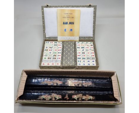 A bone and bamboo mahjong set,&nbsp;boxed; together with a set of four Chinese black lacquer counter stands. 