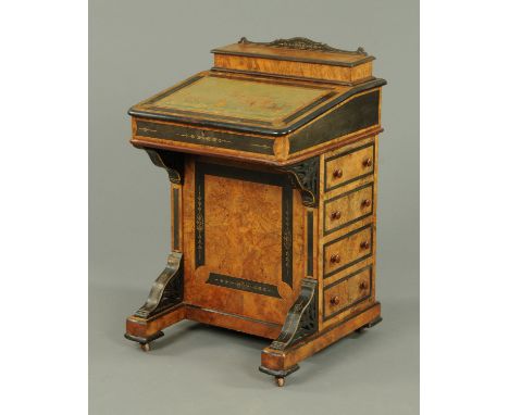 A Victorian walnut and ebonised Davenport desk, with rear stationery compartment and fitted with a series of drawers and dumm