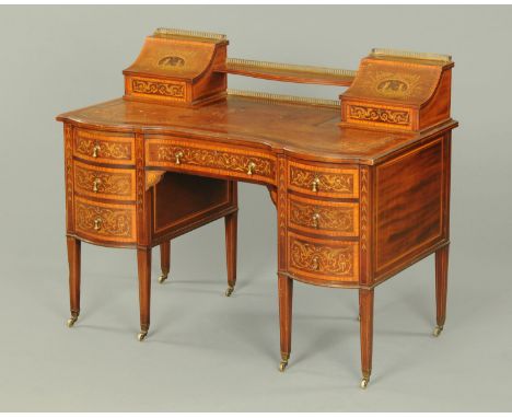 An Edwardian inlaid mahogany kneehole desk, with rear superstructure, tooled leather writing surface, serpentine front, serie
