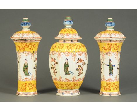 An 18th century garniture of Dutch Delft vases, each piece bearing the initials "LPK" and decorated in bright enamel colours 