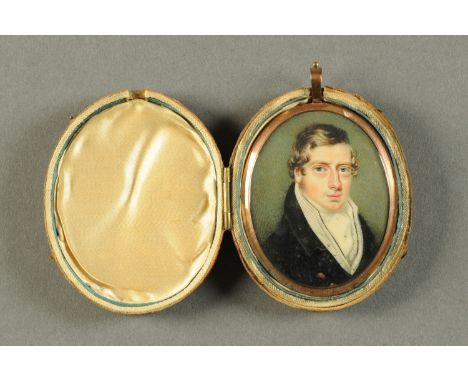 An early 19th century portrait miniature, oval, gentleman in frock coat, with hair back.  65 mm x 58 mm, cased (see illustrat