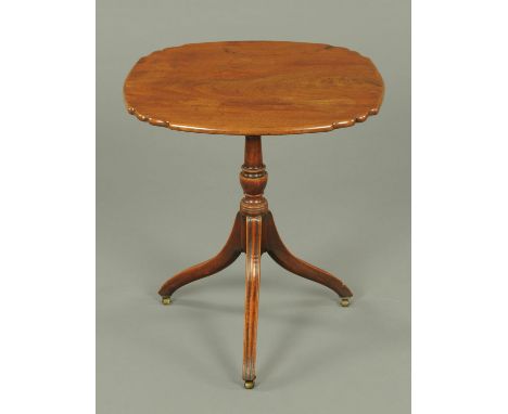 A Regency mahogany tripod table, the top of shaped outline supported by a turned column and with three downswept legs termina