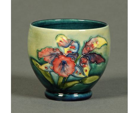A small Moorcroft bowl, with green/blue ground and bearing paper label "By Appointment, W. Moorcroft Potter to The Late Queen