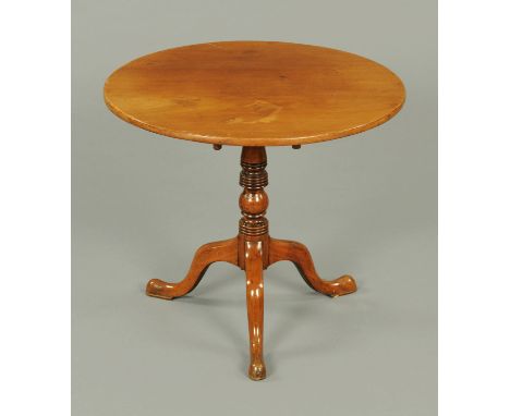 A George III mahogany tripod table, circular, with snap action, turned column and three downswept legs terminating in pad fee