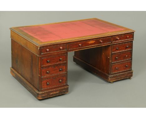 A Victorian mahogany partners desk, the rectangular top with tooled gilt red leather writing surface and rounded corners abov