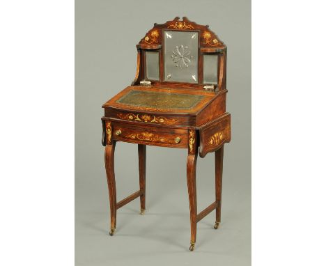An Edwardian rosewood Davenport type desk, with rear mirrored upstand, slope front and flap to either side, fitted with a fri