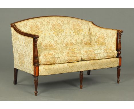 An Edwardian mahogany framed settee, in the Regency style, with exposed moulded and turned showframe and upholstered in folia