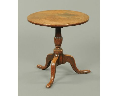 A George III oak tripod table, reduced in height, with turned column and three downswept legs terminating in pad feet.  Diame