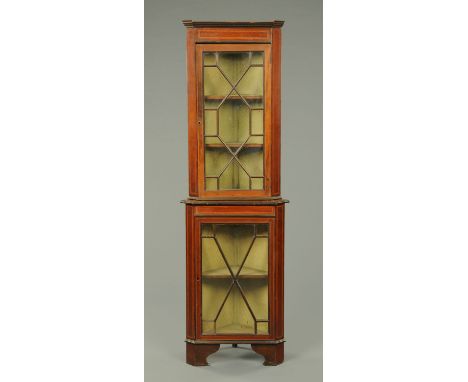 An Edwardian inlaid mahogany standing corner cupboard, with glazed top and base and raised on bracket feet.  Width 56 cm. 