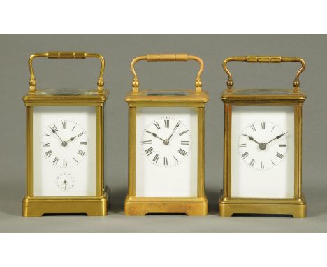 Three French brass carriage clocks, two timepieces only, one with alarm.  Tallest 13 cm.  CONDITION REPORT: The clock with th