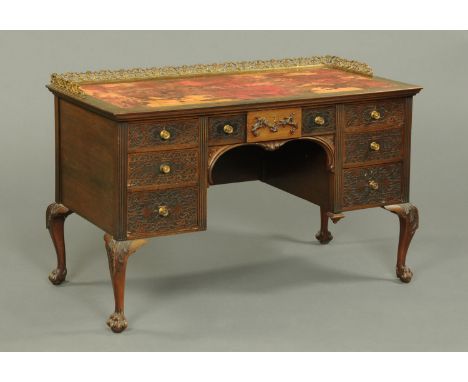 An Edwardian mahogany Chippendale style desk, with metal gallery to the rectangular top and fitted with a series or blind fre