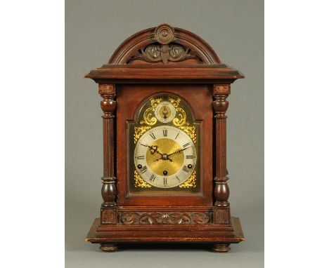 A late 19th century German three-train bracket clock, with silvered brass dial, Roman numerals, striking and chiming on five 