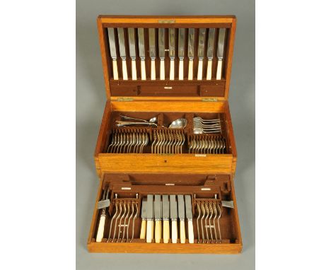 A Mappin & Webb oak cased canteen of cutlery, twelve place settings, one table fork missing, and meat and game carvers.   CON