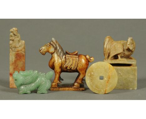 A carved jade dragon, a tsuba, Tang style horse and two pieces of carved soapstone.  Horse height 78 mm. 