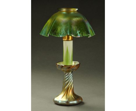 A Louis Comfort Tiffany Favrile candle lamp, circa 1910, part opal glass with green feather pattern, the base with petrol lus