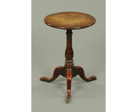 A George III mahogany tripod table, with heavy fixed top, turned centre column with three downswept legs terminating in pad f