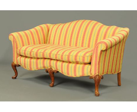 A Queen Anne style settee, with shaped back and stuffover arms, with loose cushion, serpentine front and raised on walnut she